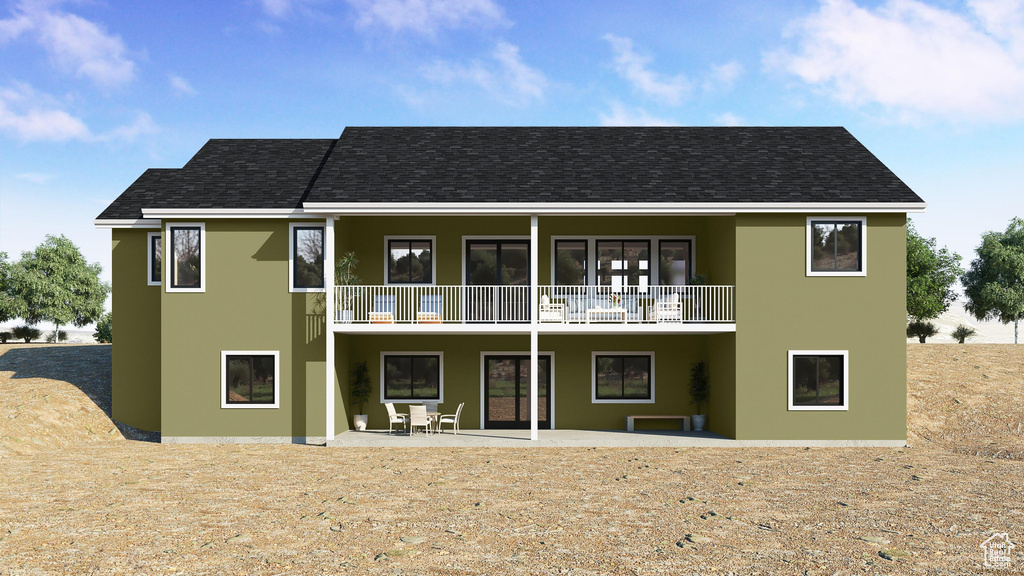 Rear view of house featuring a balcony, stucco siding, a patio, and a shingled roof