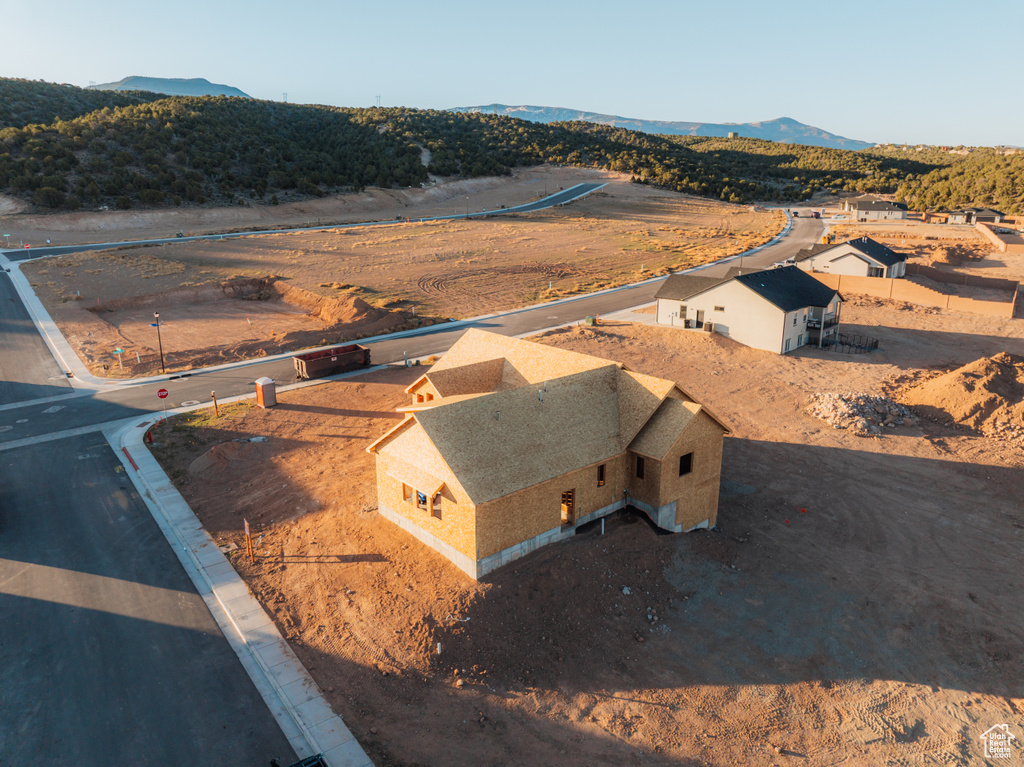 Aerial view of property and surrounding area with a mountainous background