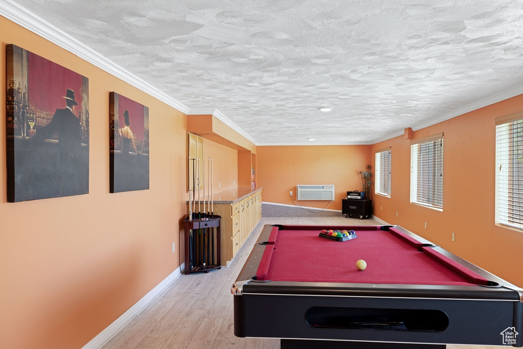 Playroom featuring light wood-style flooring, baseboards, billiards, a wall mounted air conditioner, and crown molding