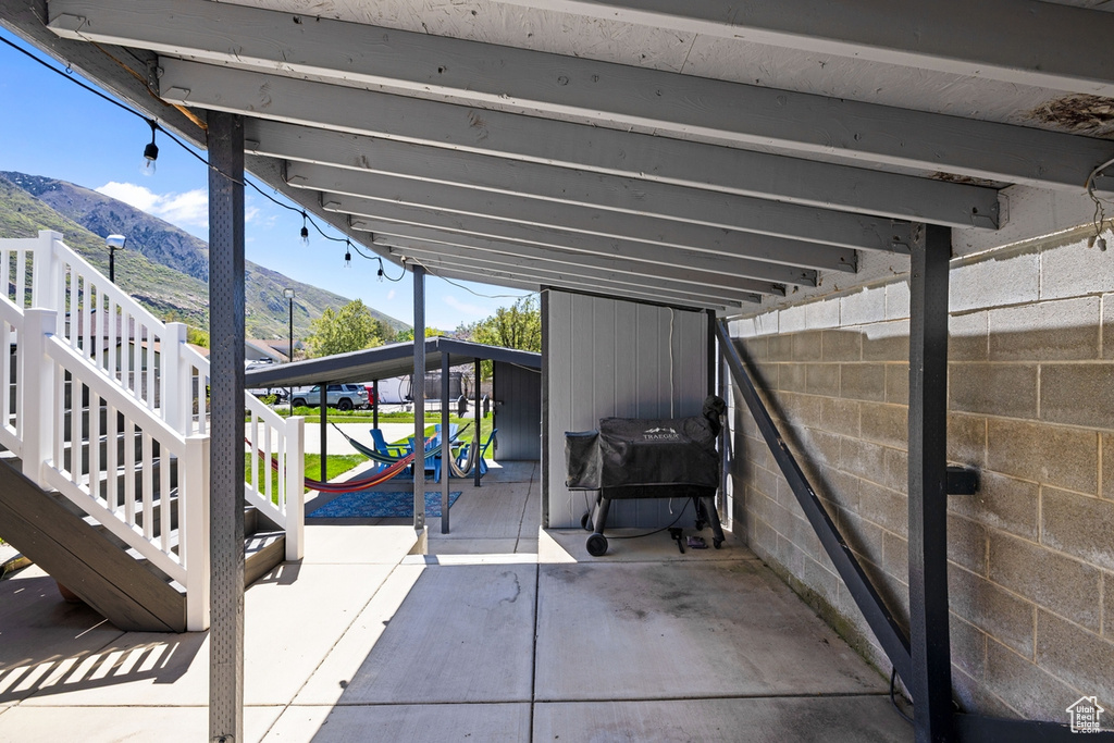 View of patio / terrace featuring stairway and a mountain view