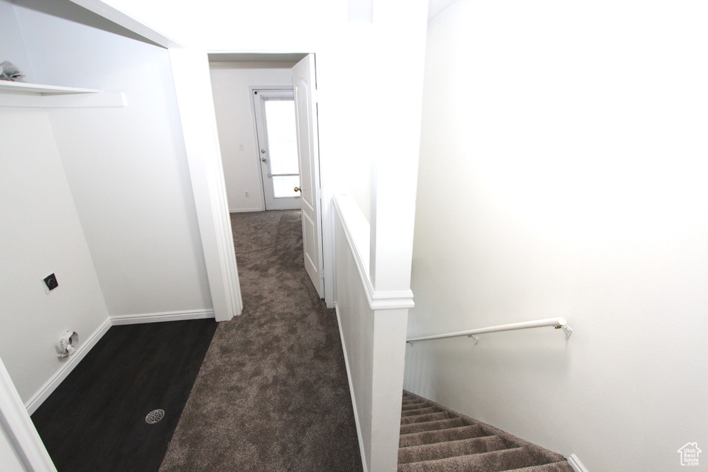 Stairs featuring wood finished floors and baseboards