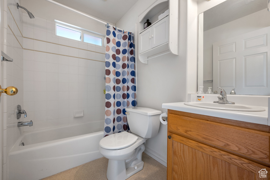 Bathroom with vanity, toilet, and shower / bath combo