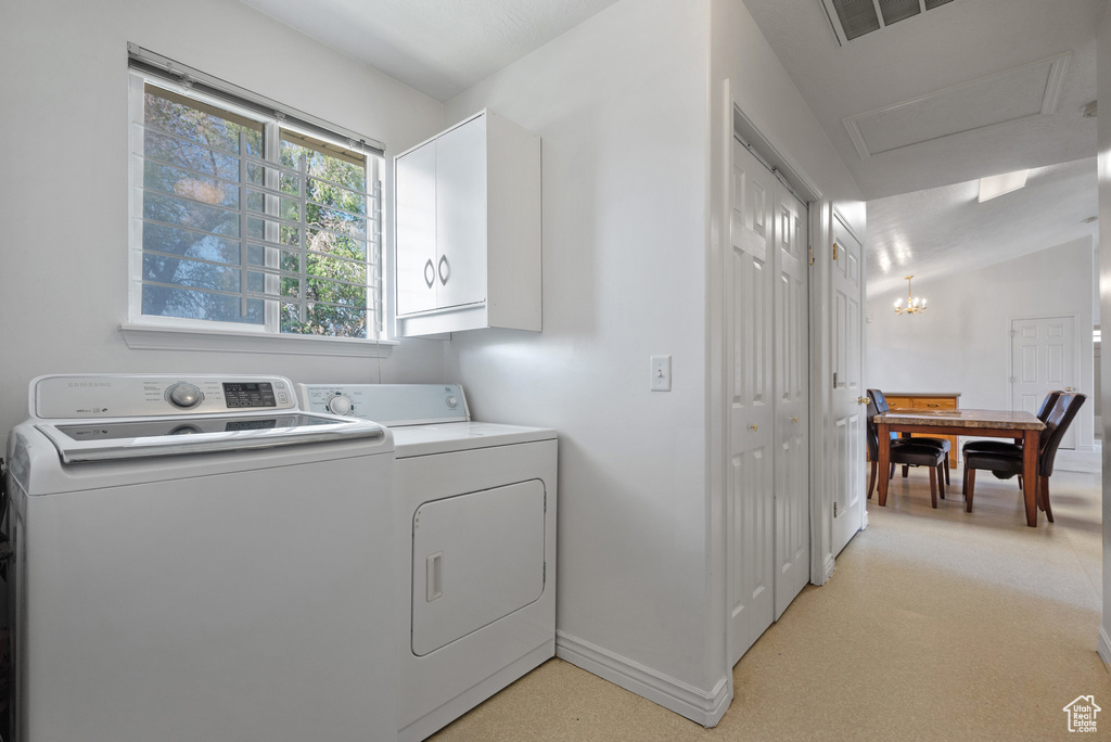 Laundry room with cabinet space, washing machine and clothes dryer, and baseboards