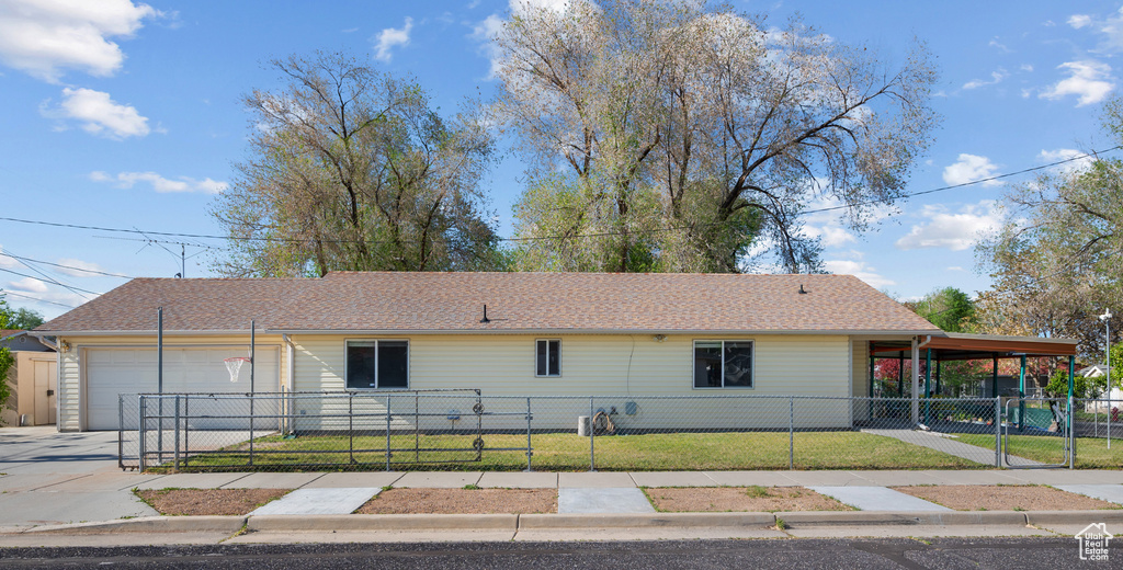 View of front of home with driveway, a gate, and a garage
