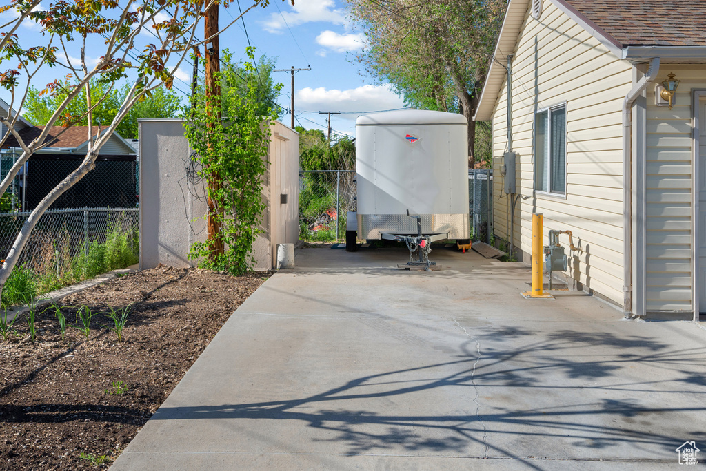 View of patio / terrace featuring fence and a storage unit