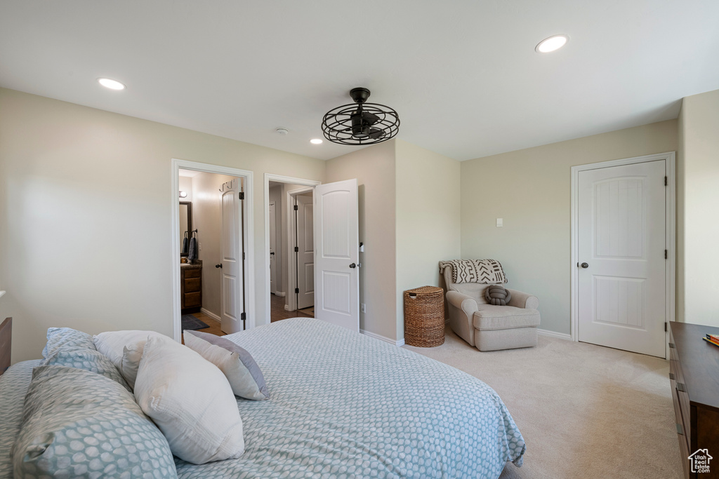 Bedroom with light colored carpet, baseboards, and recessed lighting