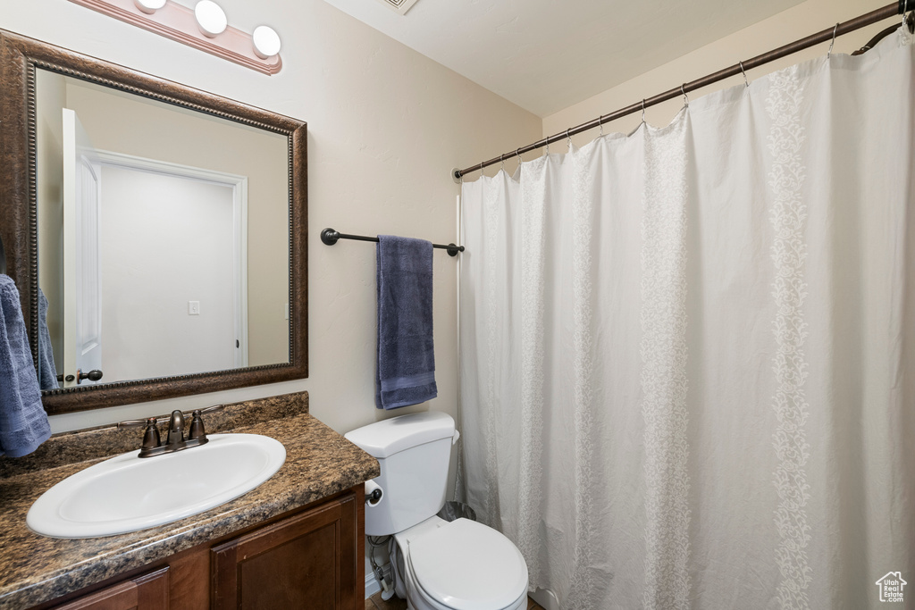 Full bathroom with toilet and vanity