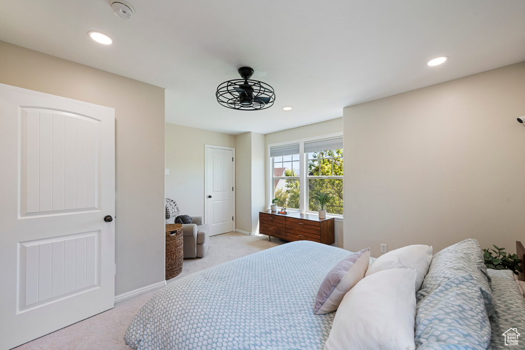 Bedroom with light colored carpet, baseboards, and recessed lighting