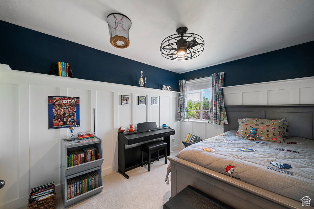 Bedroom featuring light carpet
