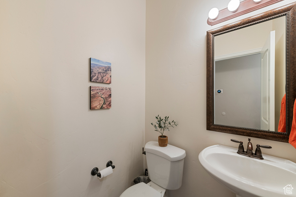 Half bath featuring a sink and toilet