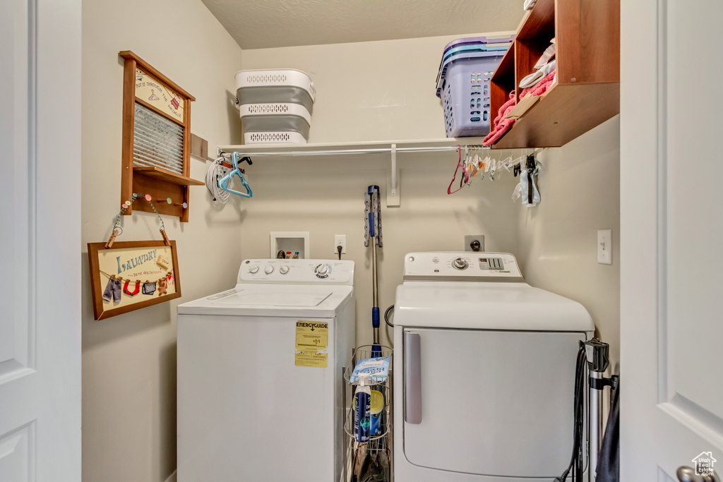 Clothes washing area featuring washing machine and dryer