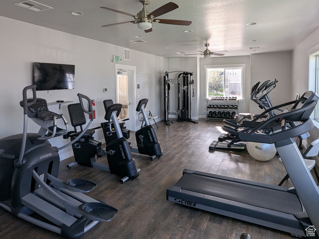 Gym featuring wood finished floors, ceiling fan, recessed lighting, and baseboards