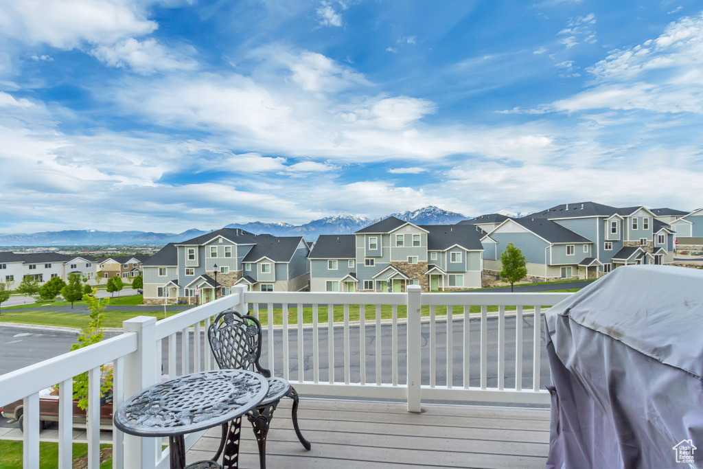 Deck with a residential view and a mountain view