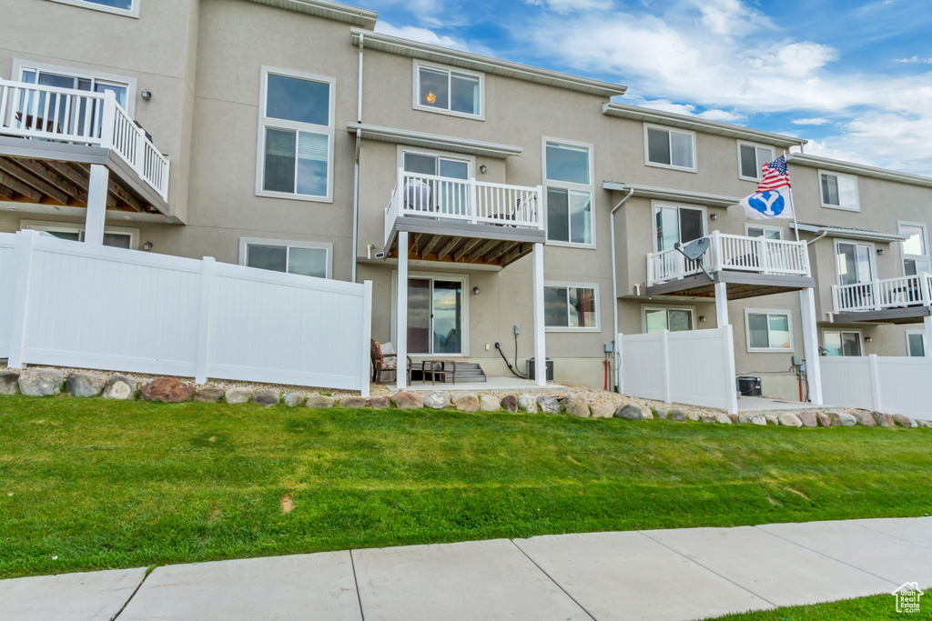 Rear view of property with stucco siding
