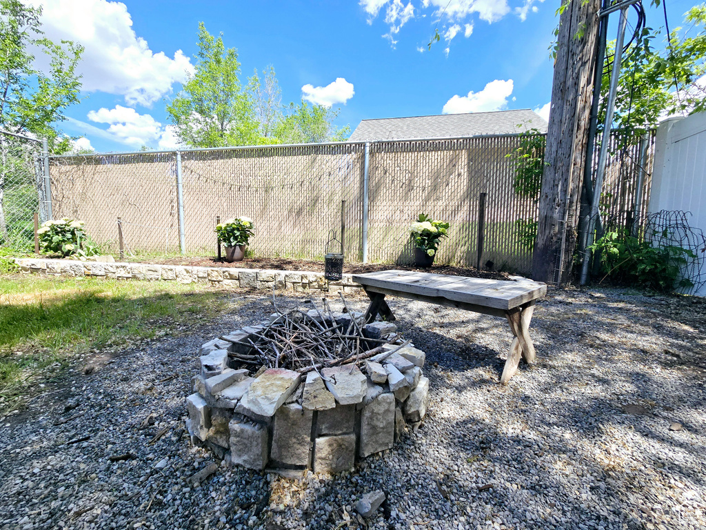 Fenced backyard featuring a fire pit