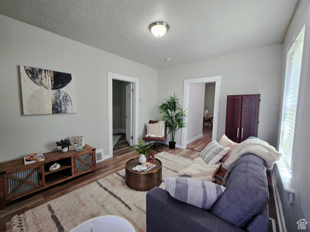 Living room with wood finished floors and baseboards