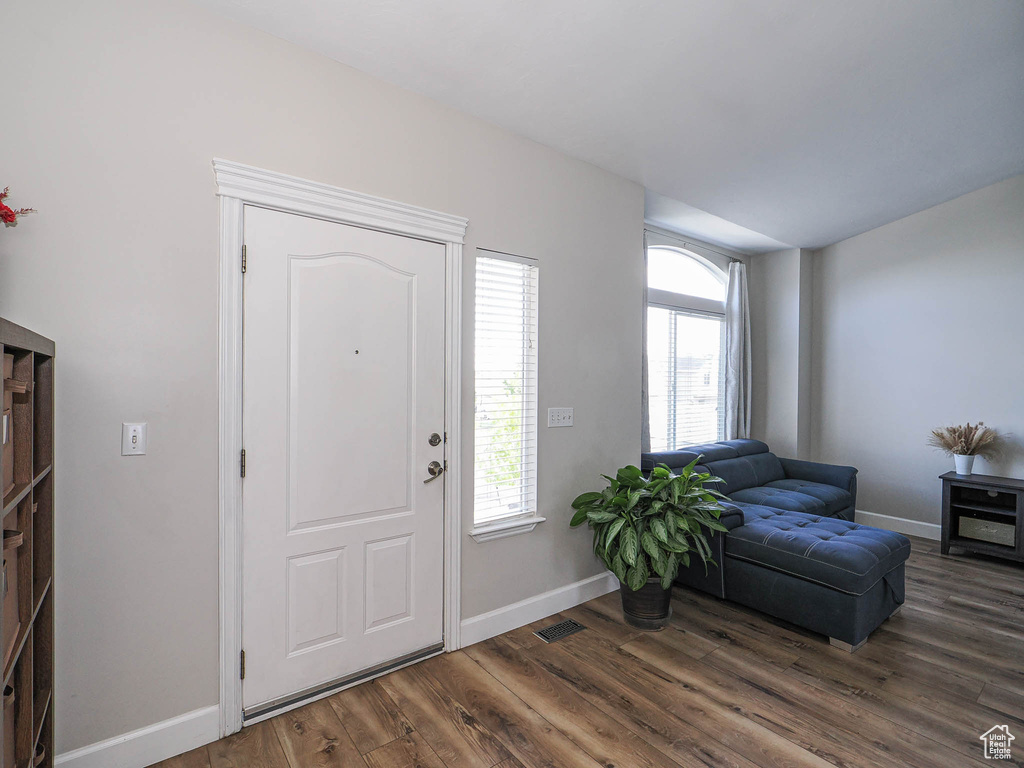 Entrance foyer with wood finished floors, plenty of natural light, and baseboards