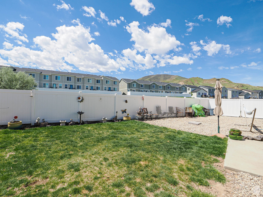 View of yard with a residential view, a mountain view, and a patio area