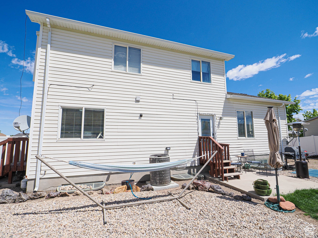Back of house with a patio, central air condition unit, and entry steps