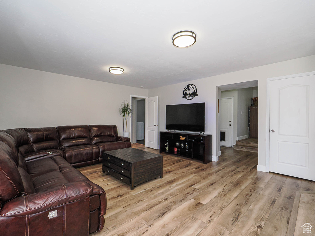 Living area with light wood-style floors and baseboards
