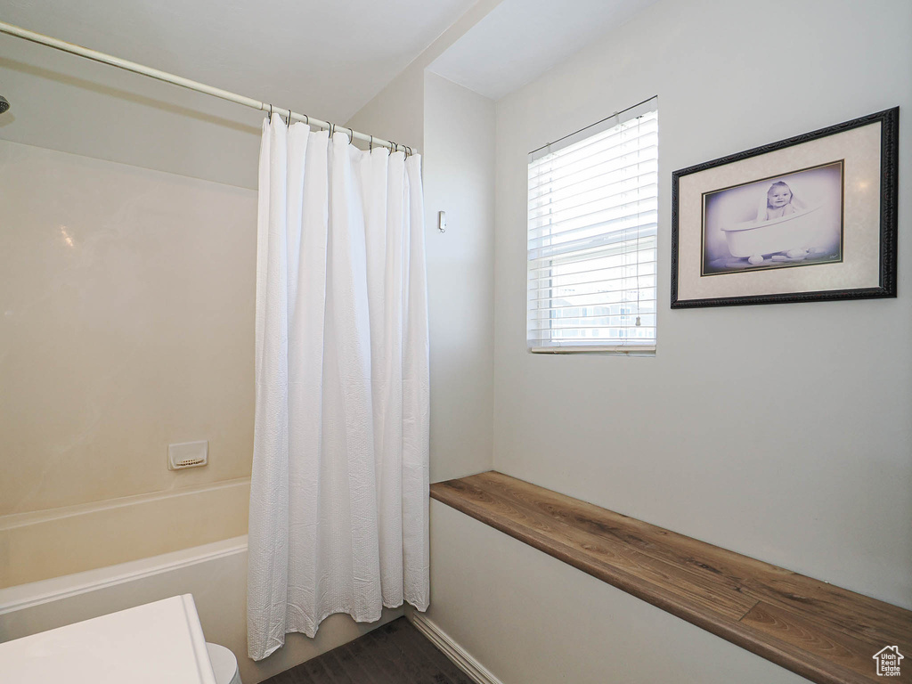 Full bathroom featuring shower / bath combo and toilet