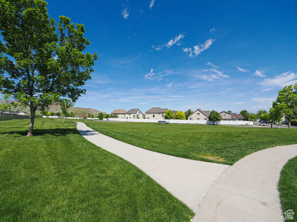 View of property's community featuring a lawn and a residential view