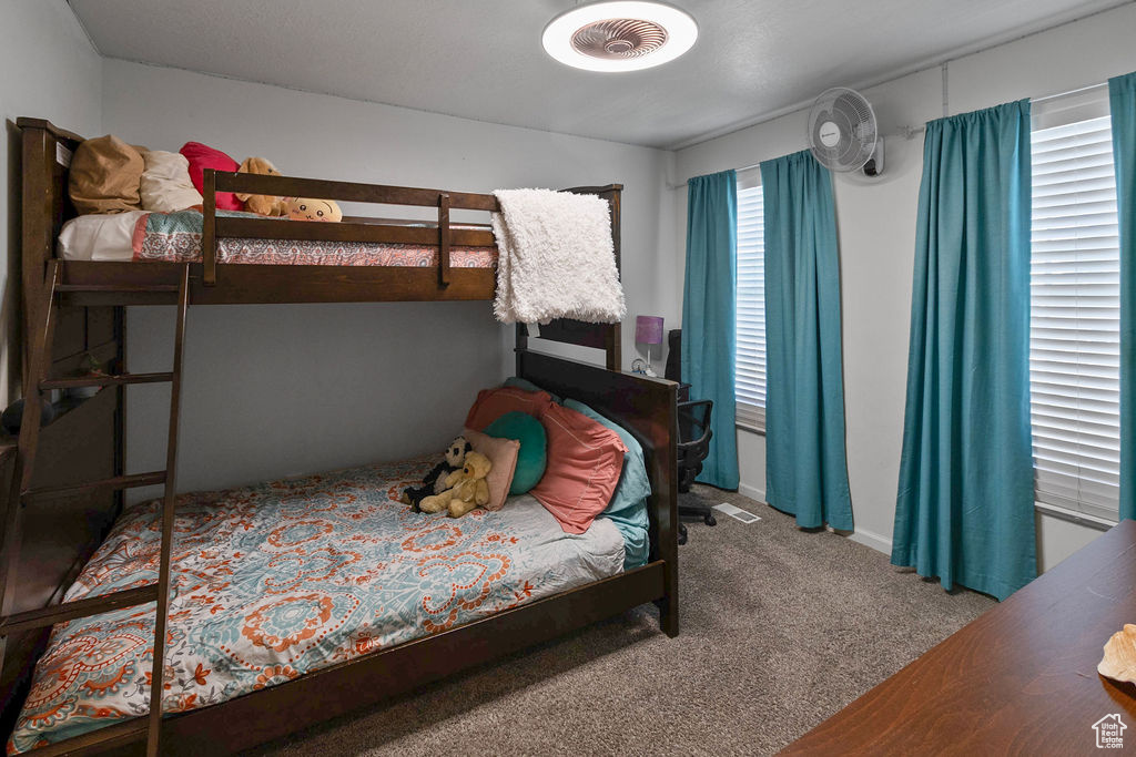 Bedroom featuring carpet floors and baseboards