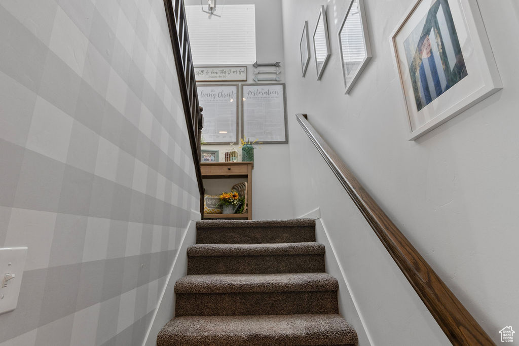 Stairs featuring wallpapered walls