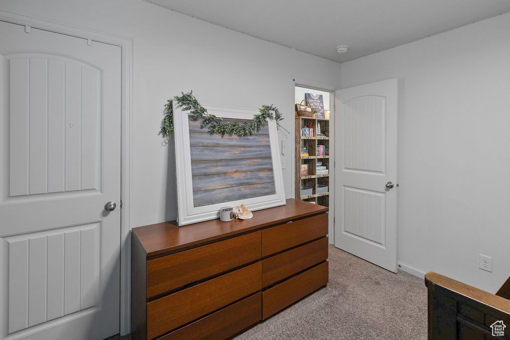Carpeted bedroom featuring baseboards