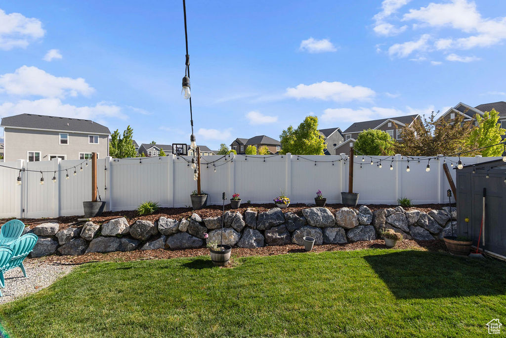 View of yard with a residential view and a gate