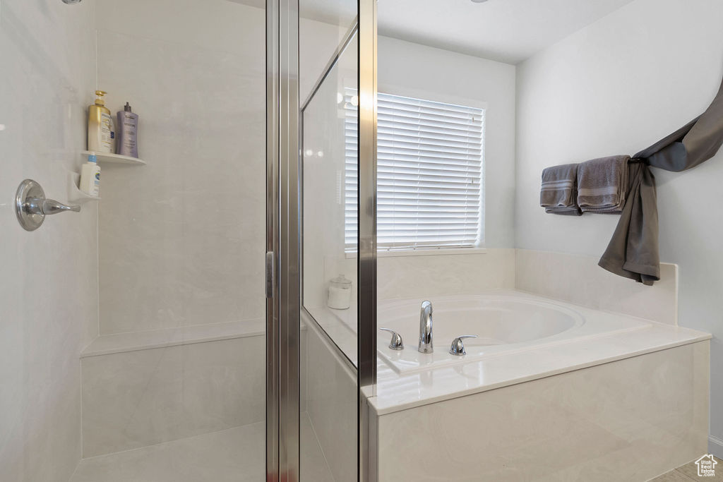 Bathroom featuring a shower stall and a garden tub