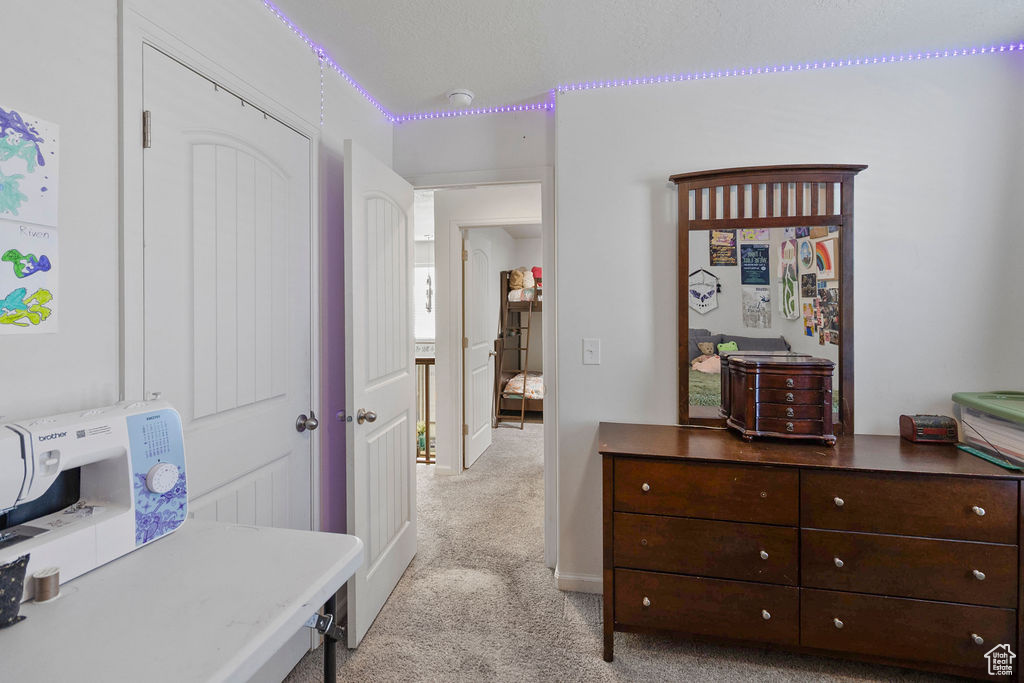 Bedroom featuring light carpet