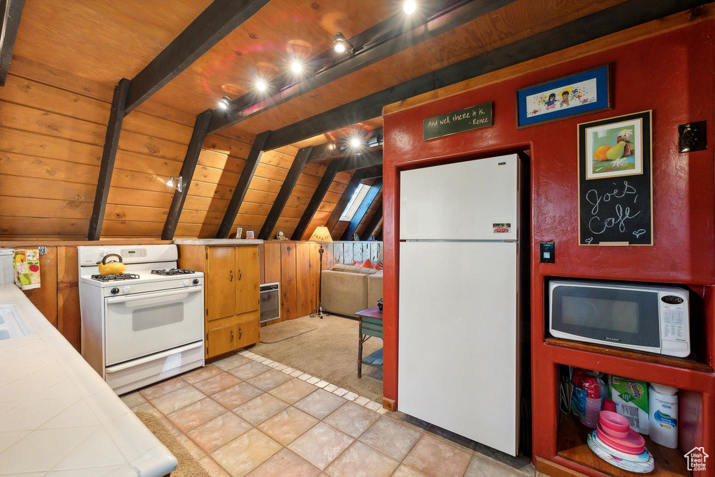 Kitchen with tile countertops, white appliances, and wood ceiling