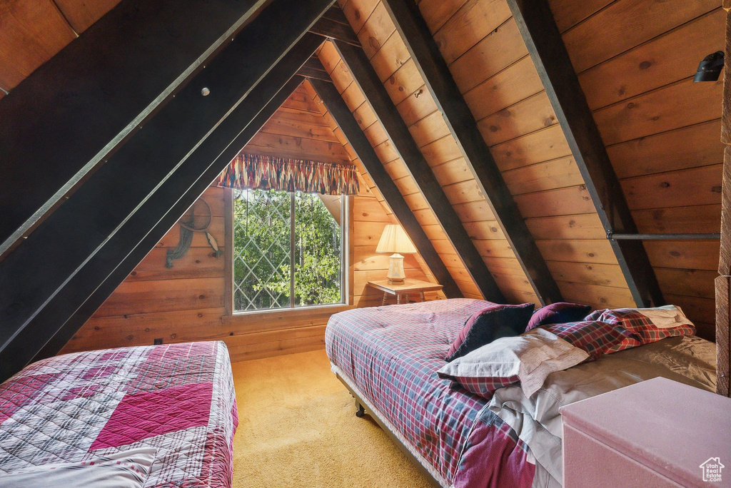 Bedroom featuring wooden walls, carpet flooring, and wooden ceiling