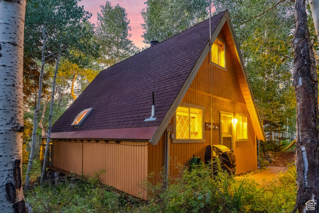 View of home\'s exterior featuring roof with shingles