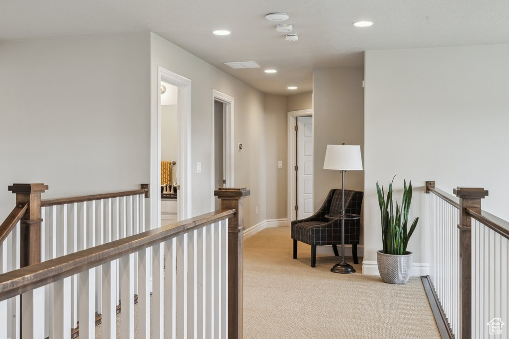 Corridor featuring an upstairs landing, carpet floors, recessed lighting, and a baseboard heating unit