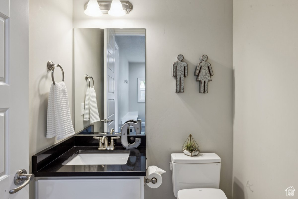 Half bathroom featuring toilet and vanity