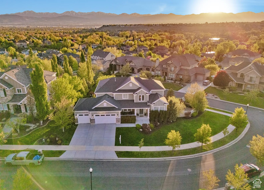 Aerial view of property\'s location featuring nearby suburban area and a mountain backdrop