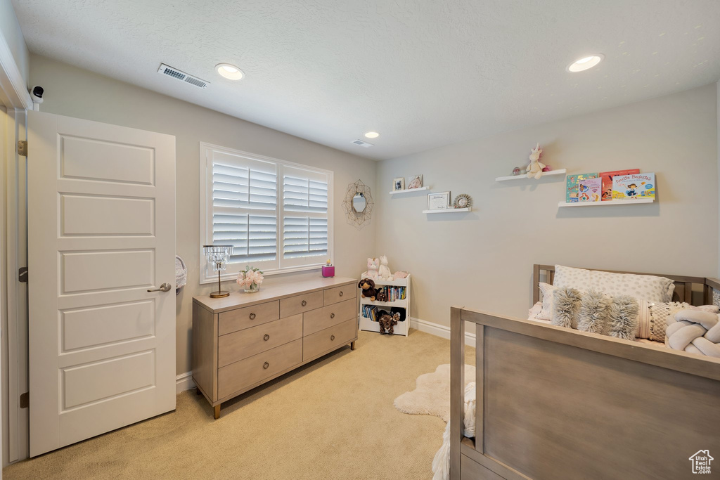 Bedroom featuring light carpet, baseboards, and recessed lighting