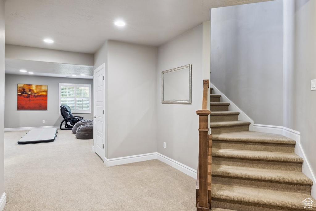 Stairs with recessed lighting, carpet flooring, and baseboards