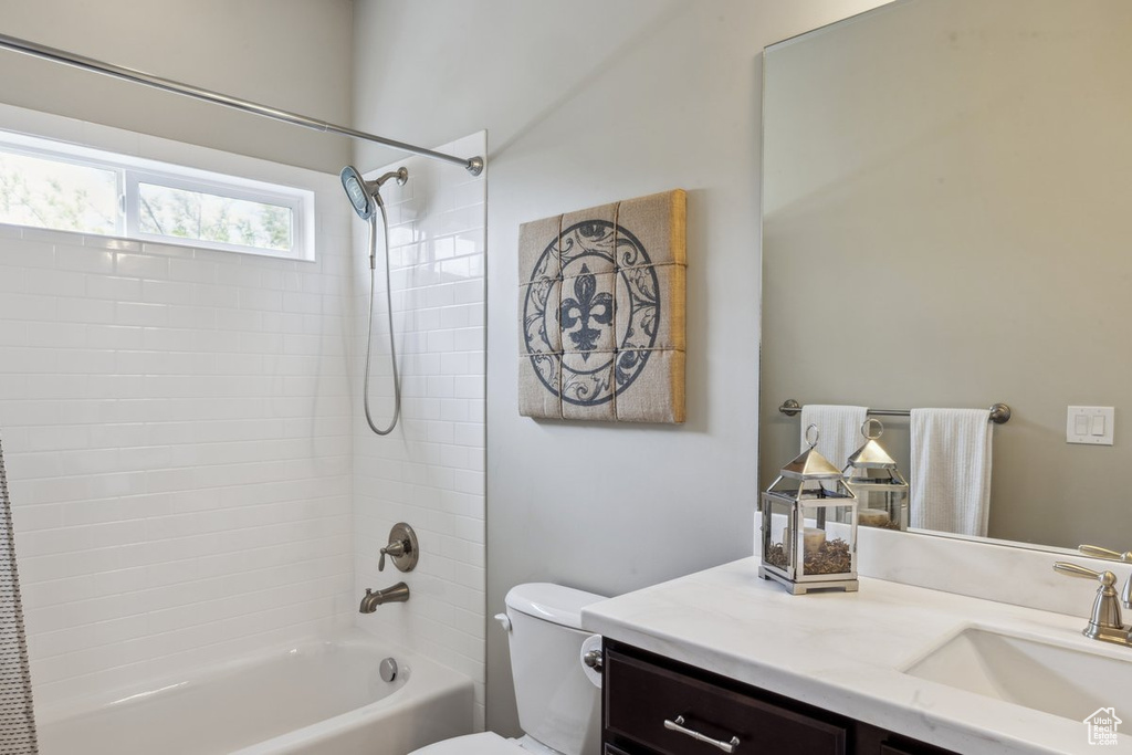 Bathroom with vanity, toilet, and washtub / shower combination