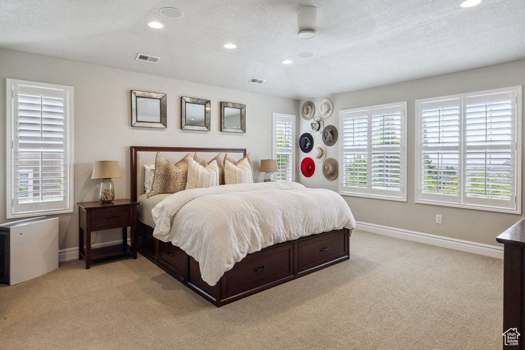 Bedroom with light carpet, baseboards, and recessed lighting