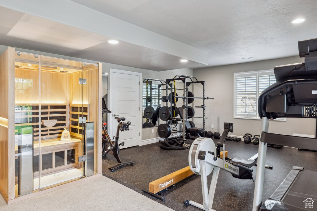 Exercise room with recessed lighting and baseboards