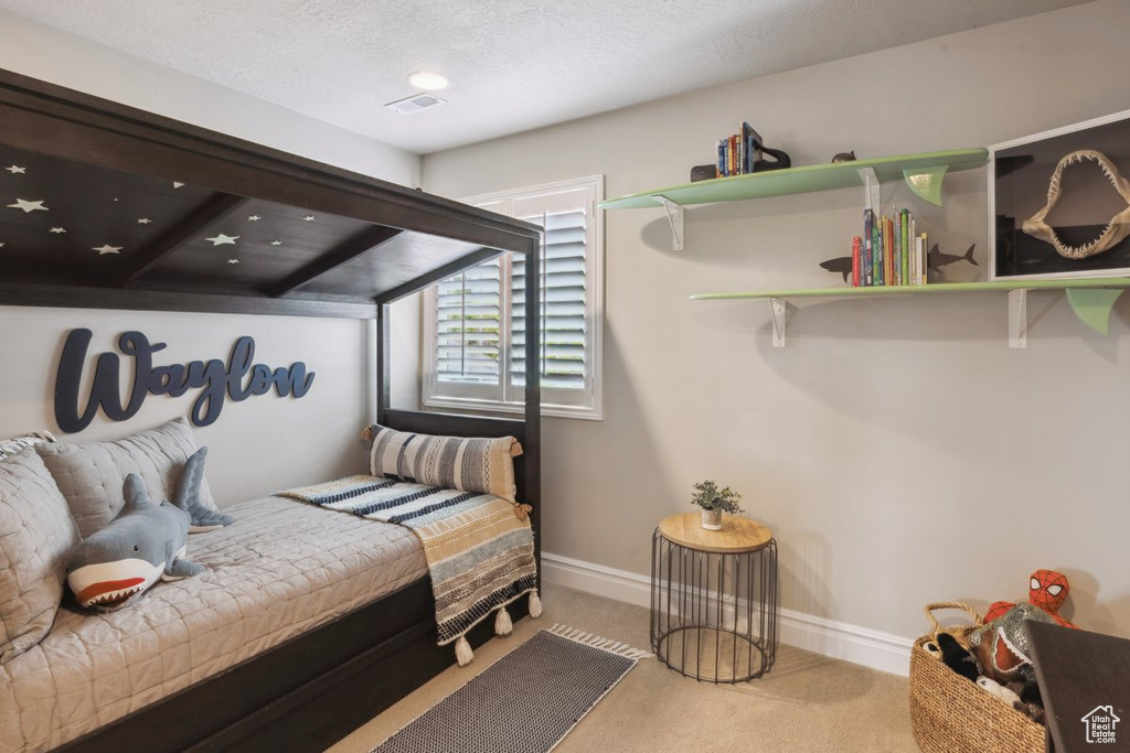 Carpeted bedroom with baseboards