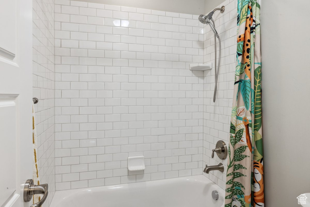 Bathroom featuring shower / bathtub combination with curtain