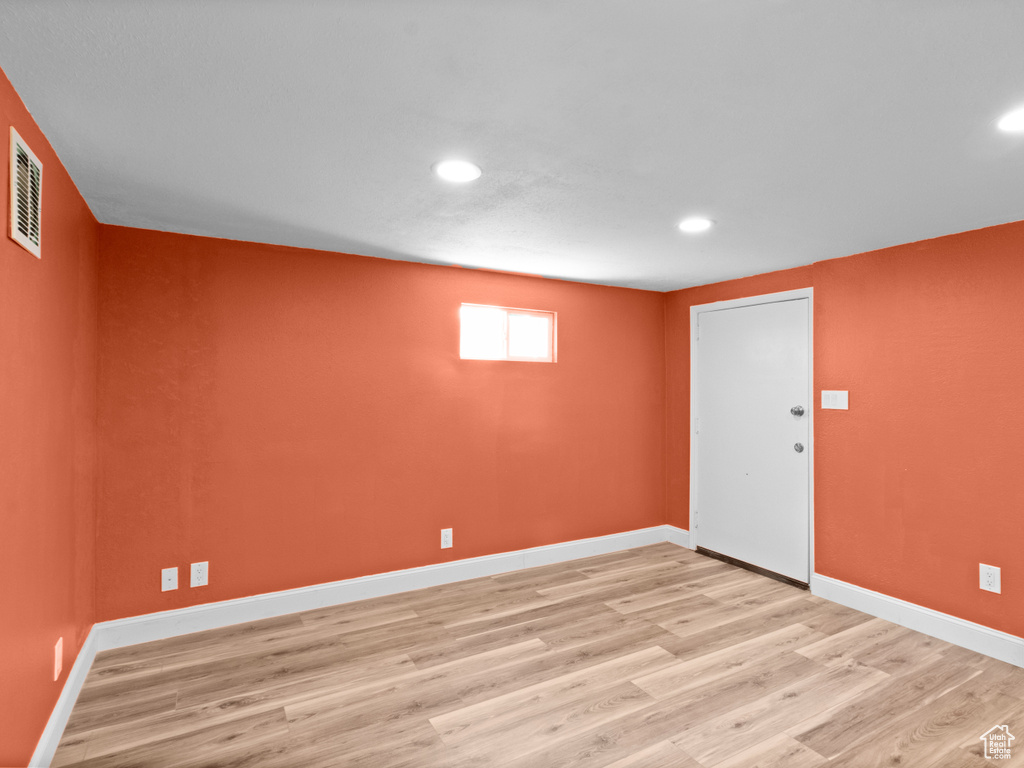 Basement featuring recessed lighting, light wood finished floors, and baseboards