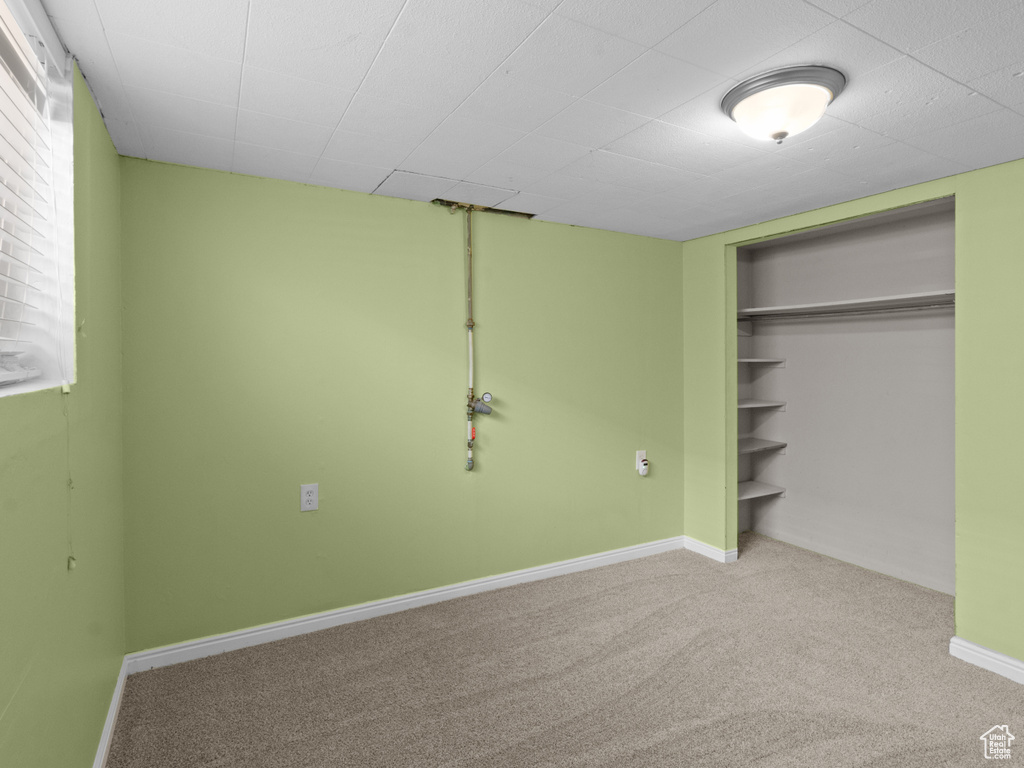 Unfurnished bedroom featuring carpet flooring, a closet, and baseboards
