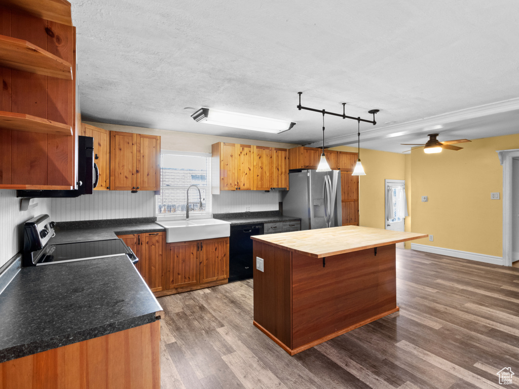 Kitchen with stainless steel refrigerator with ice dispenser, a sink, electric range, dishwasher, and dark wood-style flooring