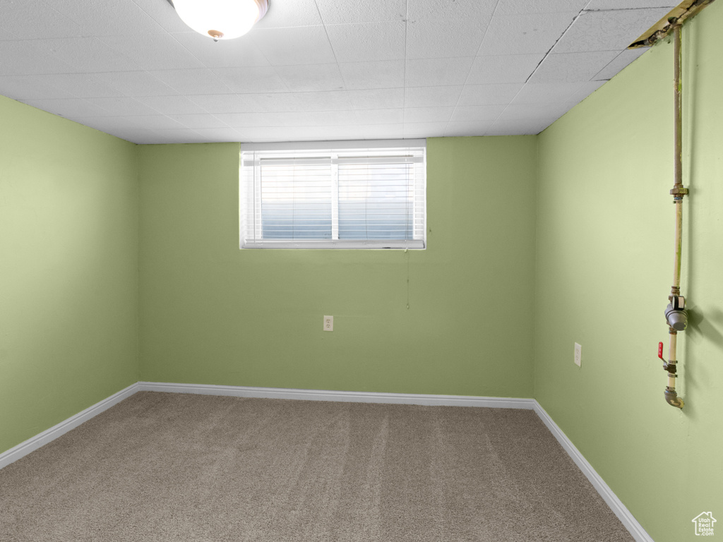 Carpeted empty room with baseboards