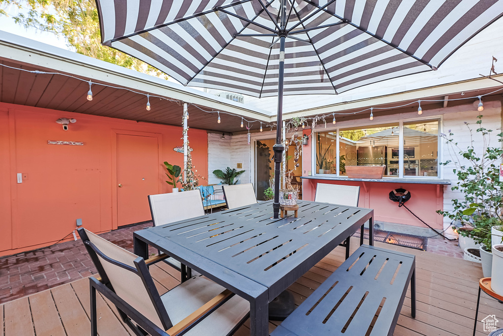 Wooden terrace featuring outdoor dining space